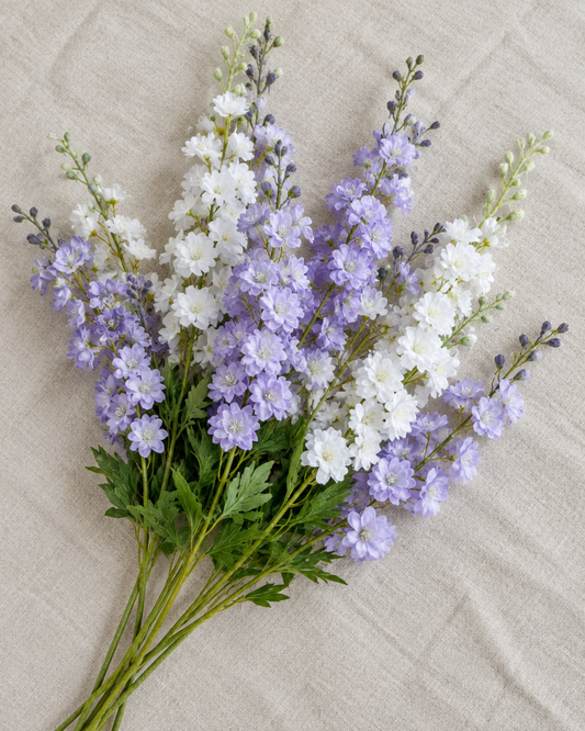 Lilac Purple Artificial Delphinium Flower Stems, shown alone on a linen background