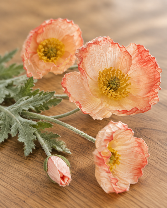 Close-up detail of the peach artificial poppy stem on an oak table