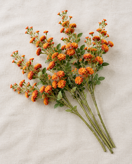 Burnt Orange Artificial Blossom Stems, shown alone on a linen background