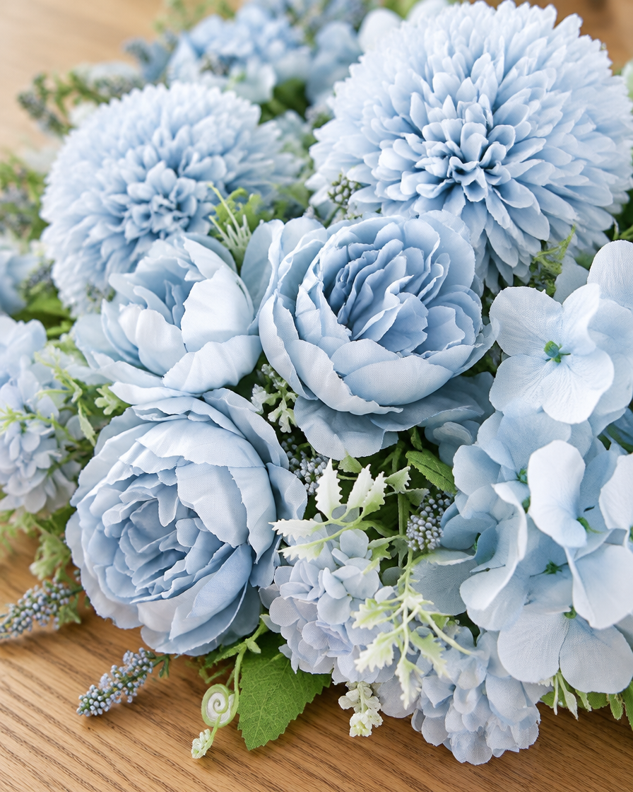 Close-up detail of the light blue artificial peony & pompom mixed bouquet on an oak table