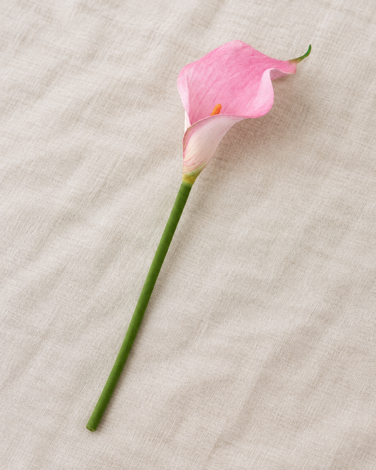 Pink Artificial Calla Lily Stem, shown alone on a linen background