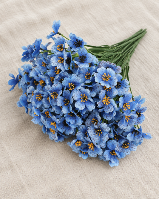 Blue Artificial Flower Bunch, shown alone on a linen background