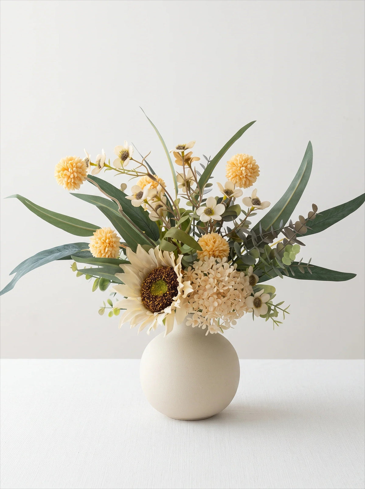 Creamy white globe vase styled