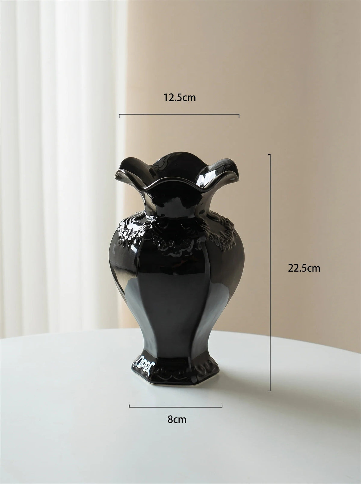 Ruffled black vase in a room