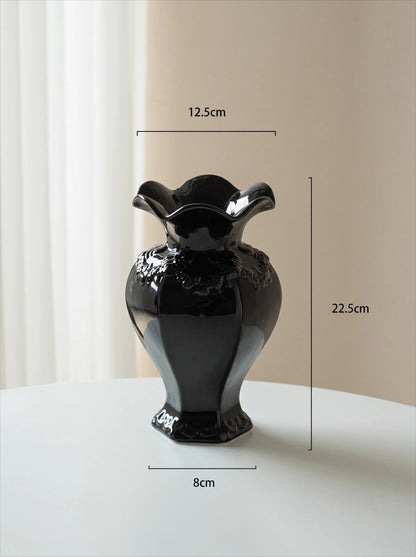 Ruffled black vase in a room