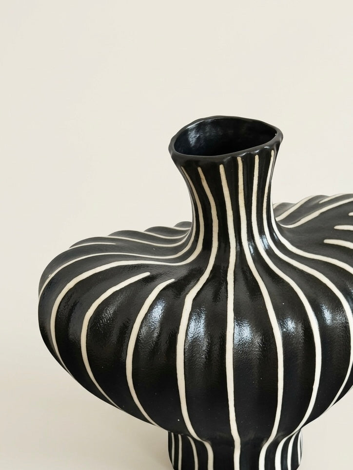 Striped sculptural vase styled