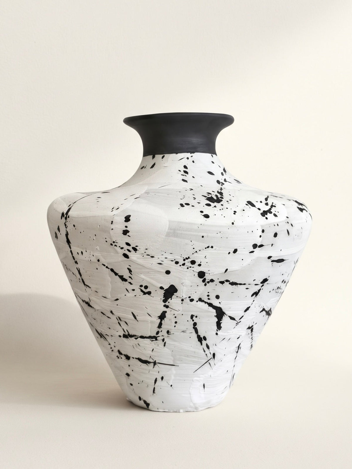 White ceramic vase with black splatter glaze