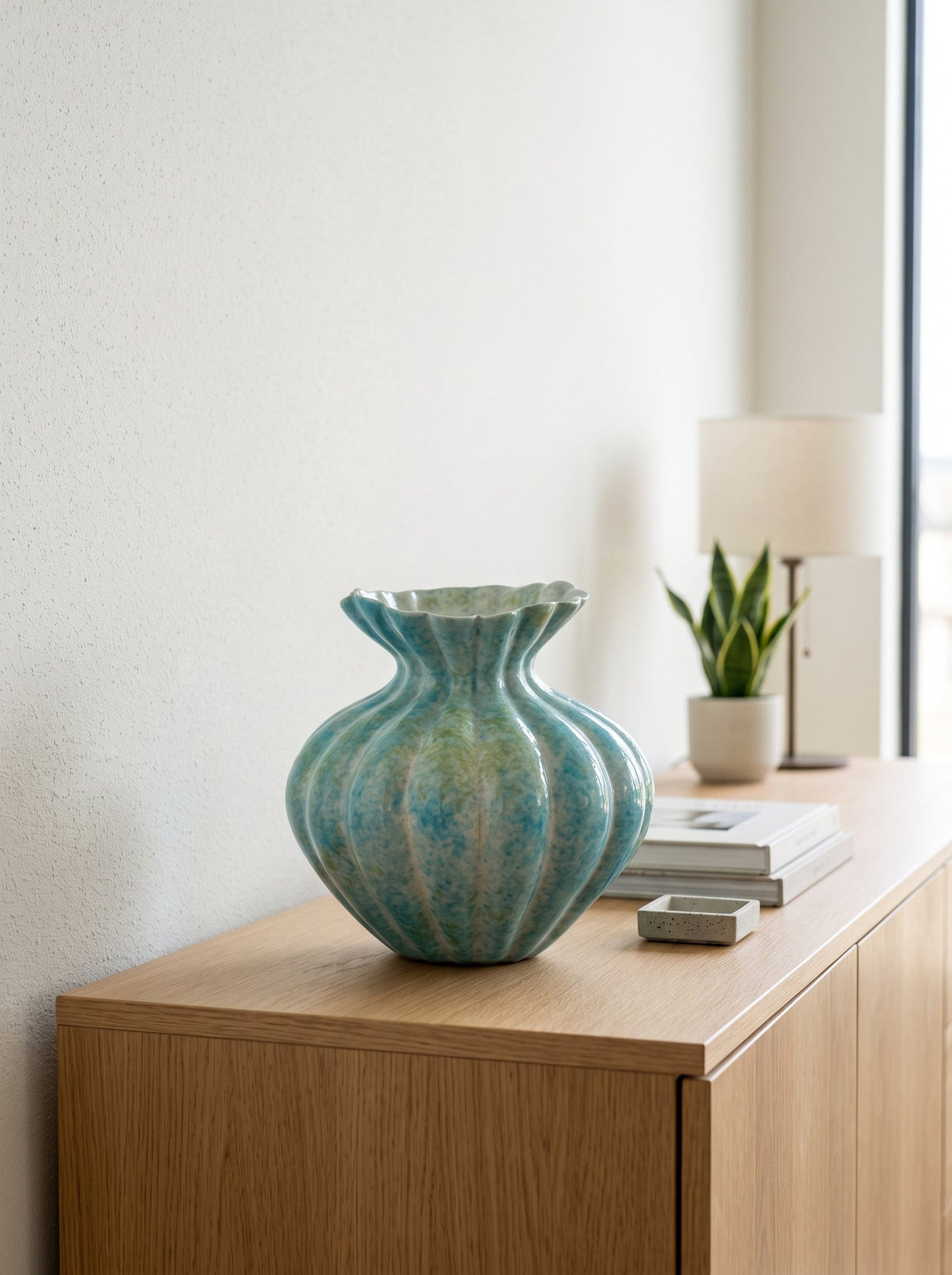 Mint blue fluted vase on a shelf