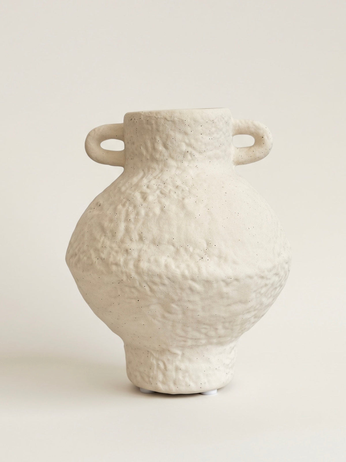 Speckled ceramic urn vase, empty, front view showing the two small handles