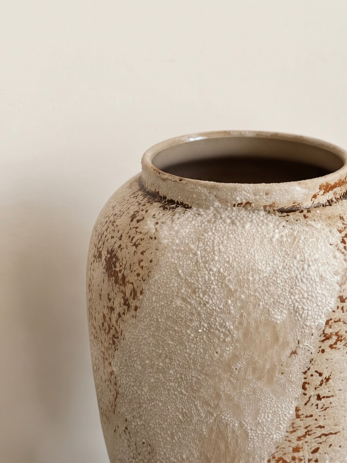Rust streak ceramic vase styled with stems