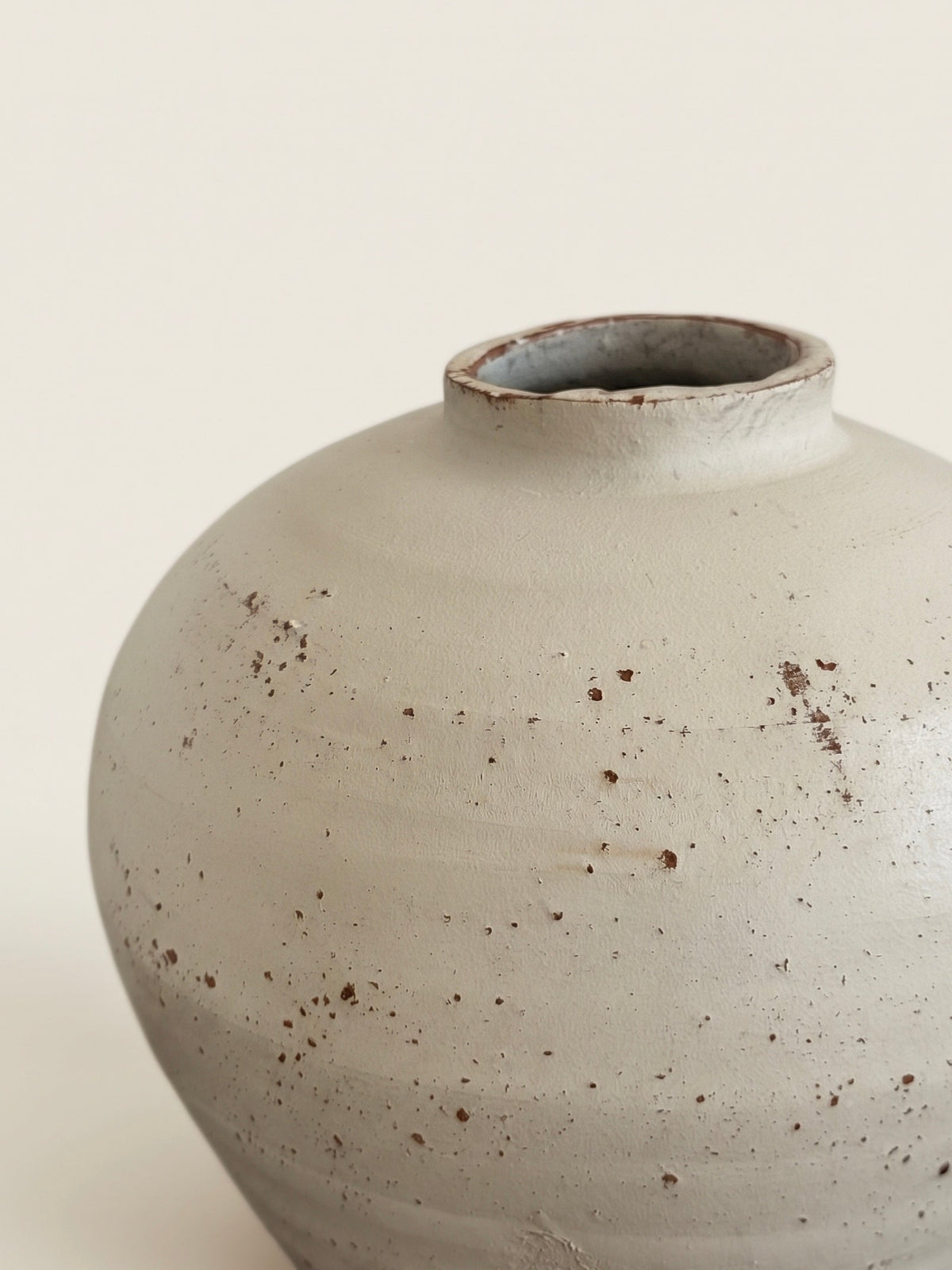 Speckled ivory urn vase styled on a shelf