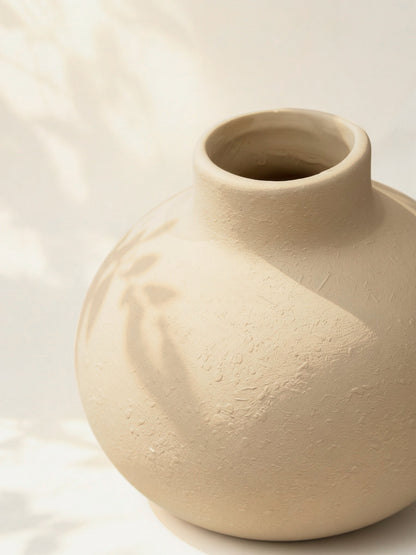 Creamy white globe vase side view