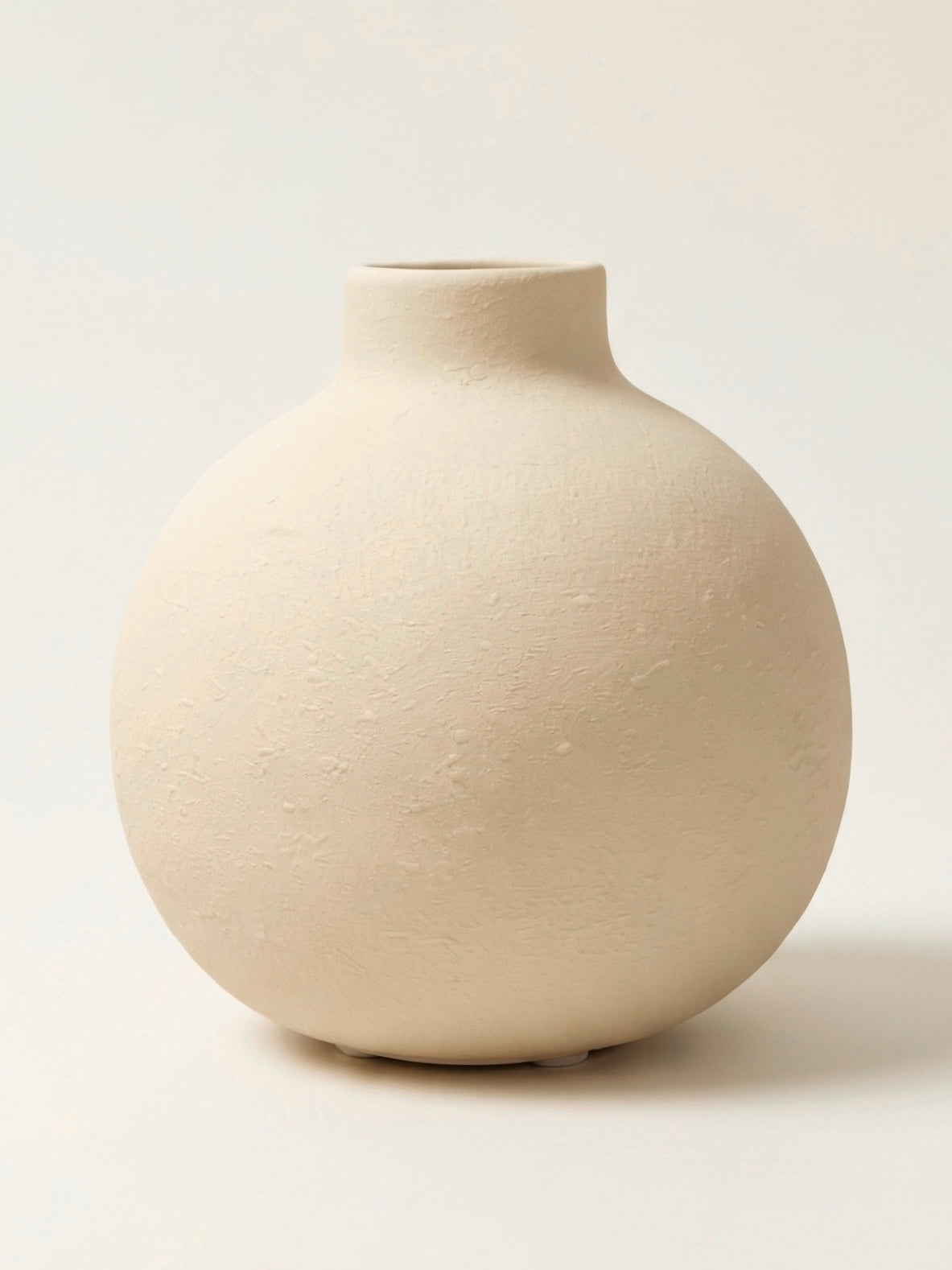Creamy white textured globe vase