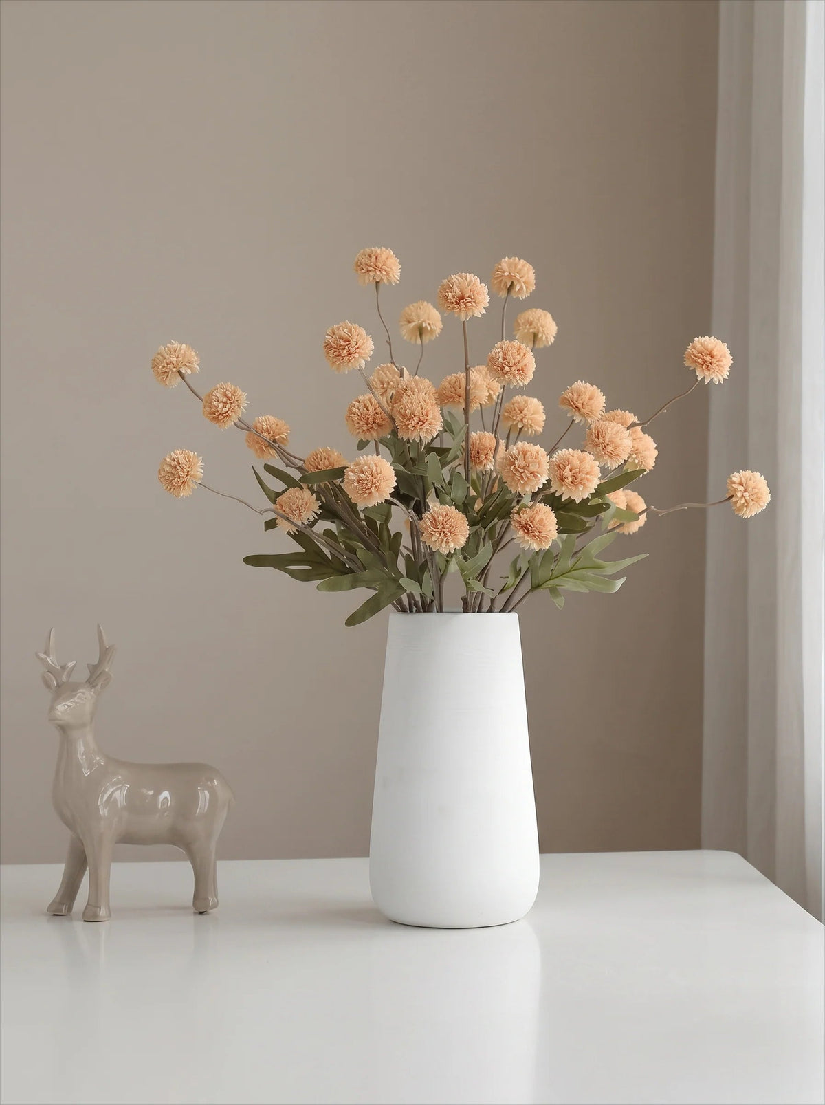Golden pom-pom arrangement in a vase