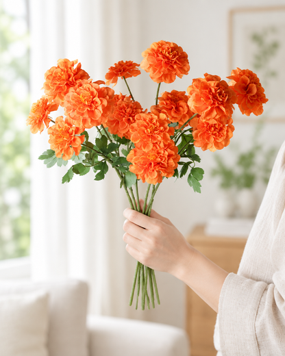 Orange Artificial Marigold Stems held in a hand