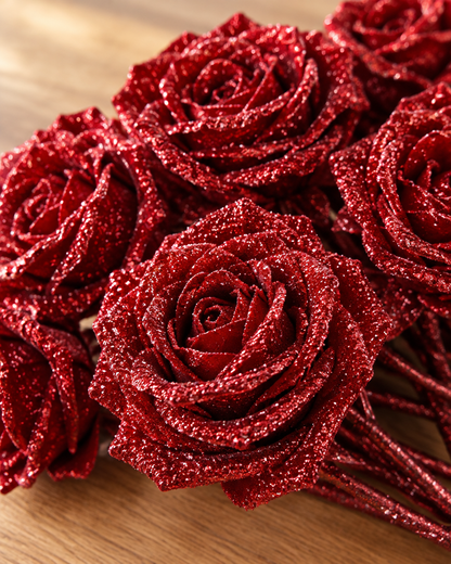 Close-up detail of the red glitter artificial rose bouquet on an oak table