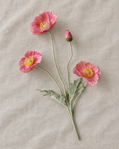 Pink Artificial Poppy Stem, shown alone on a linen background