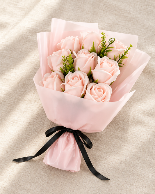 Pink Wrapped Artificial Rose Bouquet, shown alone on a linen background