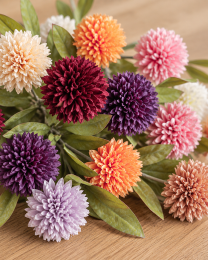 Close-up detail of the mixed colour artificial dandelion ball flower stems on an oak table