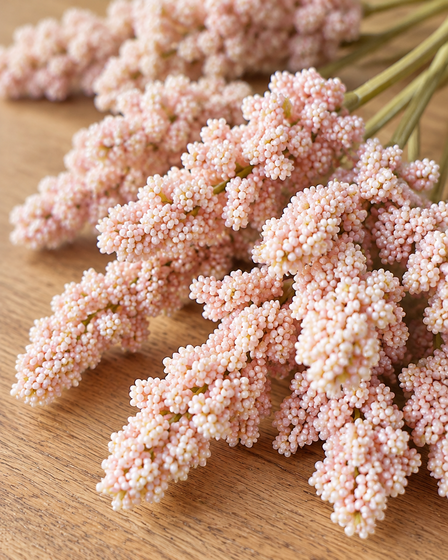 Close-up detail of the blush pink artificial lavender bunch on an oak table