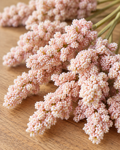 Close-up detail of the blush pink artificial lavender bunch on an oak table