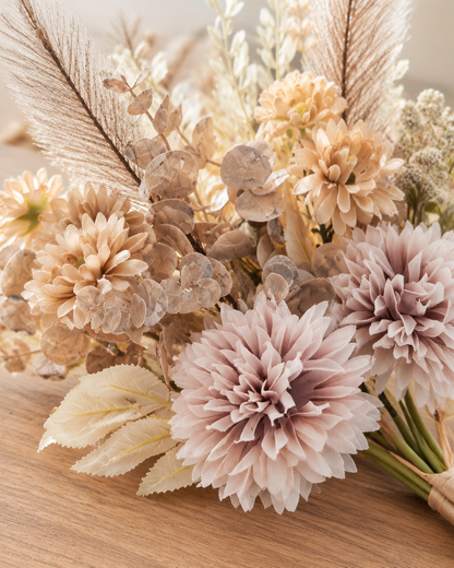 Close-up detail of the beige artificial mixed dahlia & pampas bouquet on an oak table