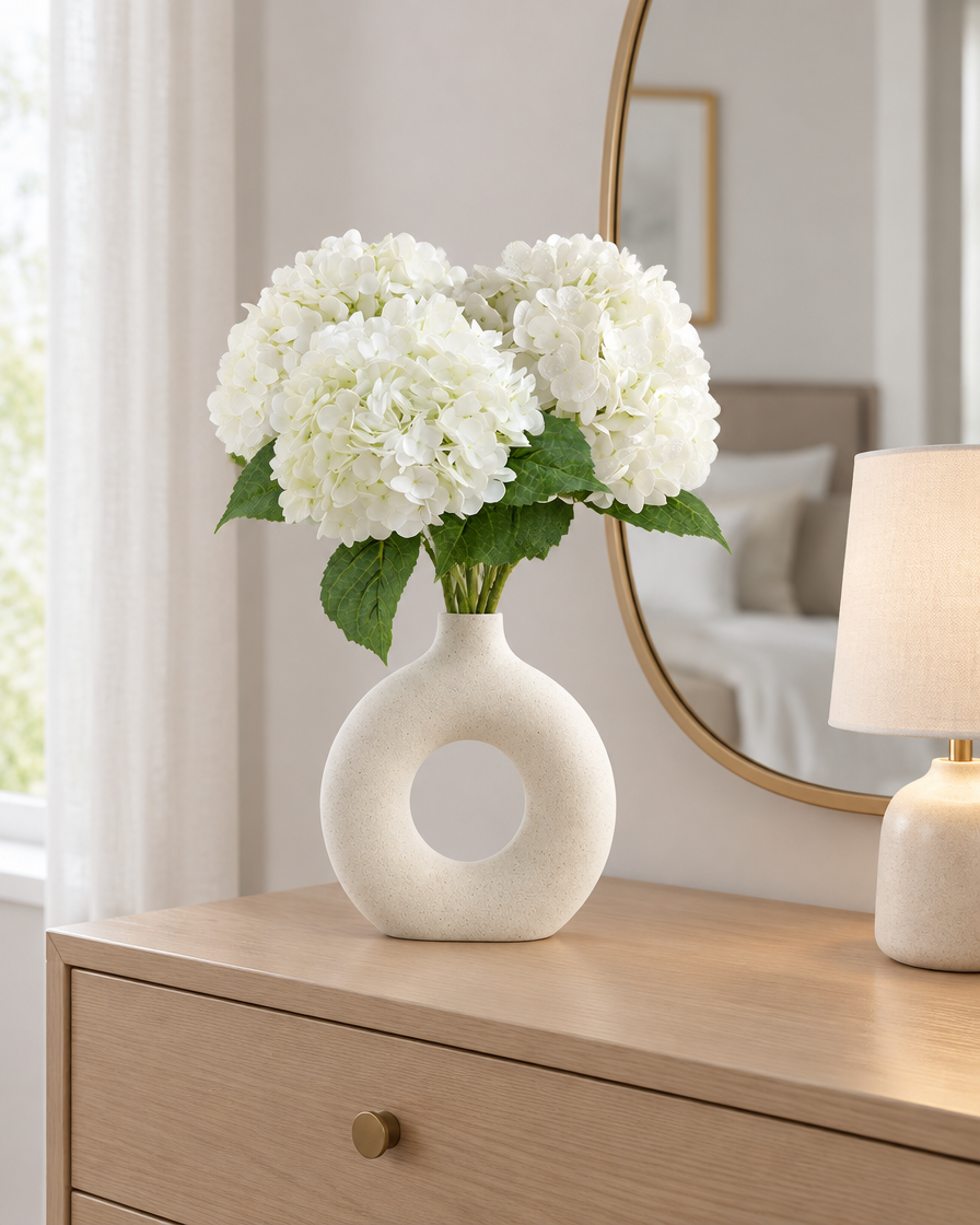 White Artificial Hydrangea Stems styled in a ceramic vase on a dresser (vase sold separately)