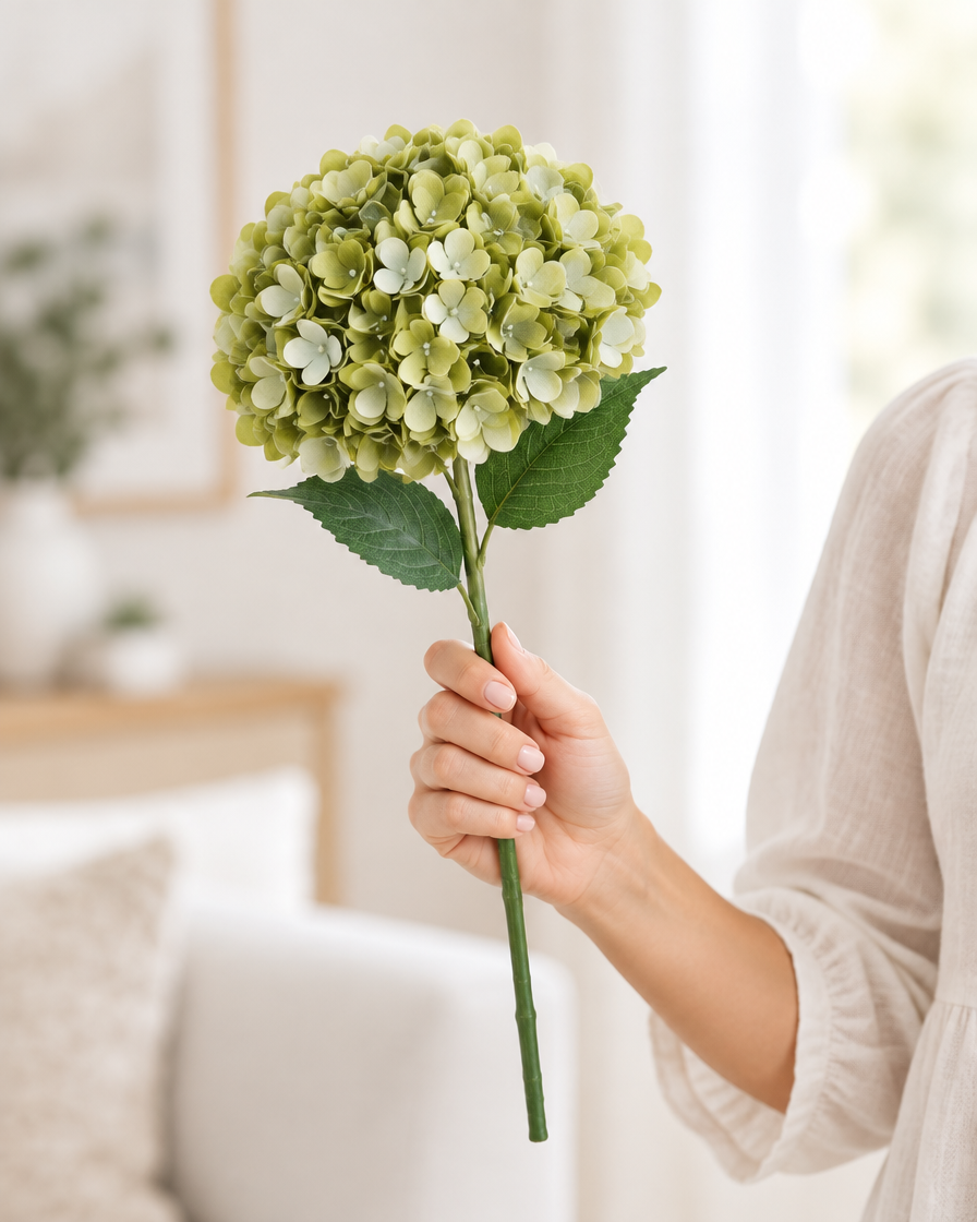 Sage Green Artificial Hydrangea Stem held in a hand