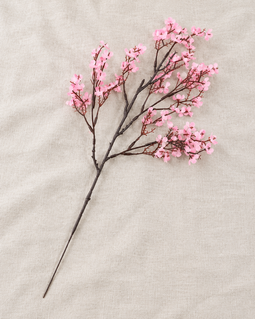 Pink Artificial Blossom Branch, shown alone on a linen background
