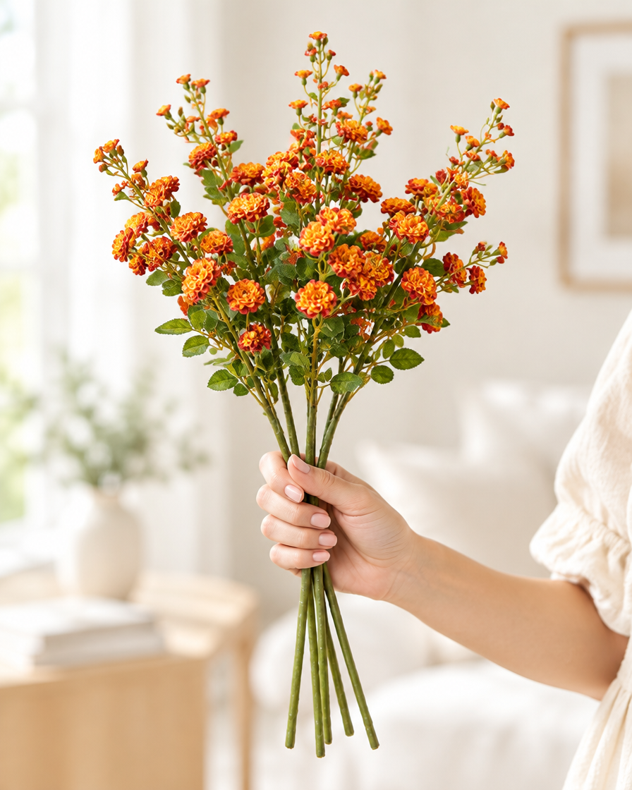 Burnt Orange Artificial Blossom Stems held in a hand