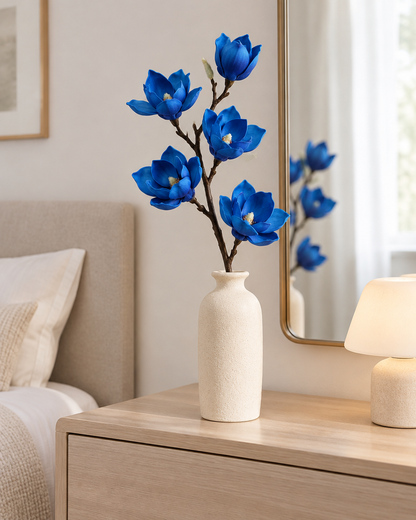 Royal Blue Artificial Magnolia Branch styled in a ceramic vase on a dresser (vase sold separately)