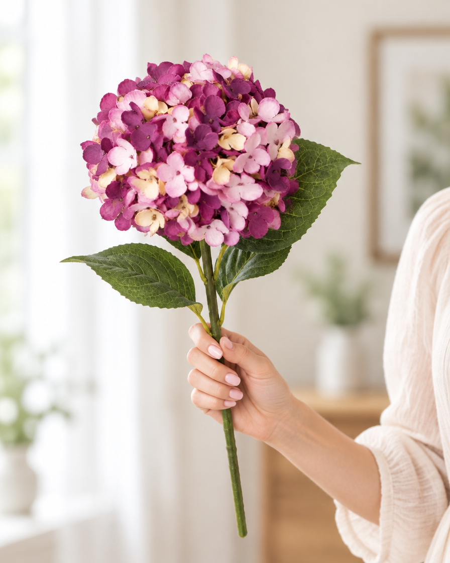 Plum Purple Artificial Hydrangea Stem held in a hand
