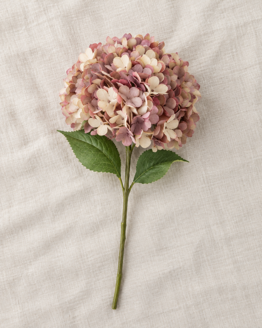 Dusty Pink Artificial Hydrangea Stem, shown alone on a linen background