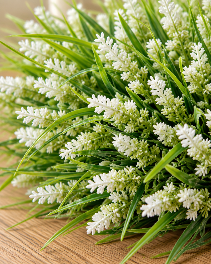 Close-up detail of the white artificial lavender and grass bunch on an oak table