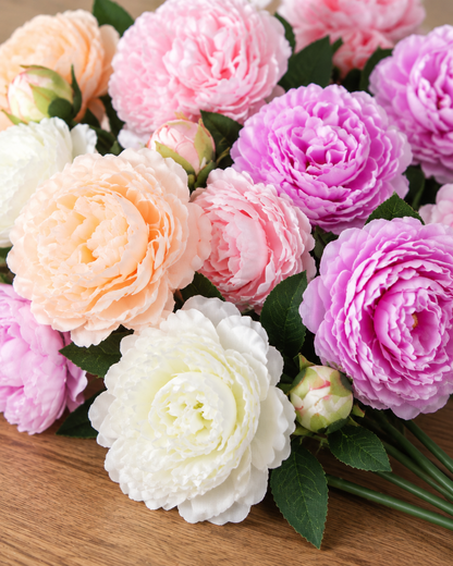 Close-up detail of the mixed colour artificial peony bouquet on an oak table