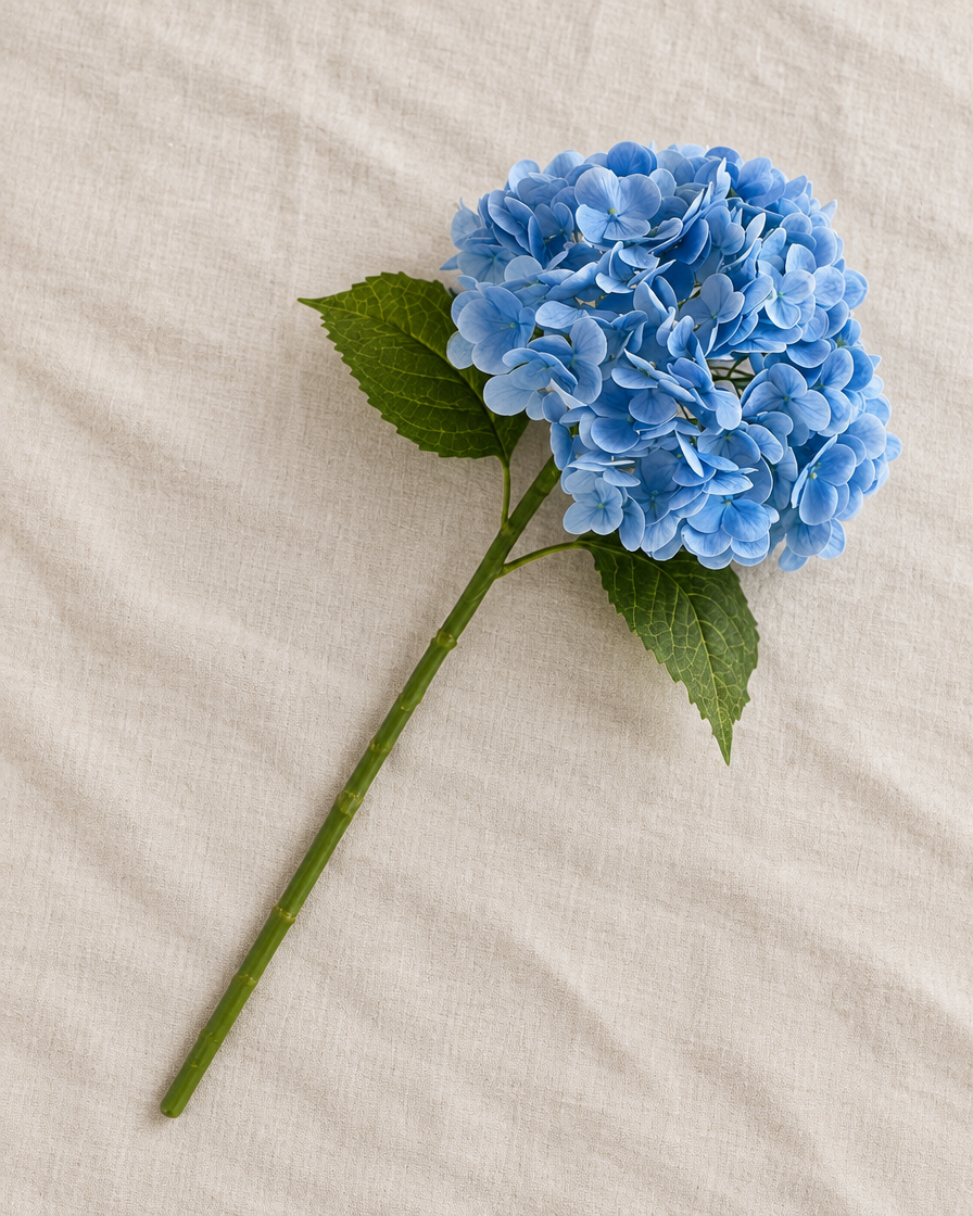 Blue Artificial Hydrangea Stem, shown alone on a linen background