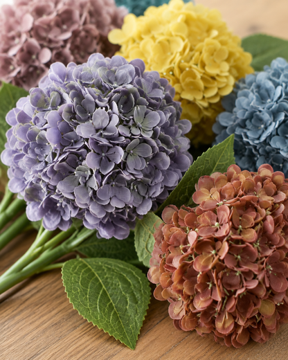 Close-up detail of the multicolour artificial hydrangea bouquet on an oak table