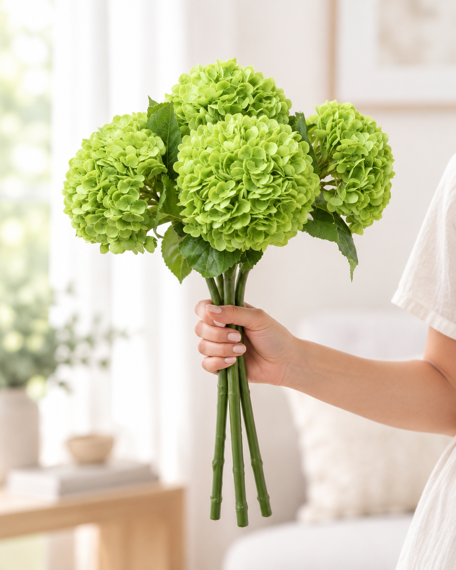 Apple Green Artificial Hydrangea Stems held in a hand