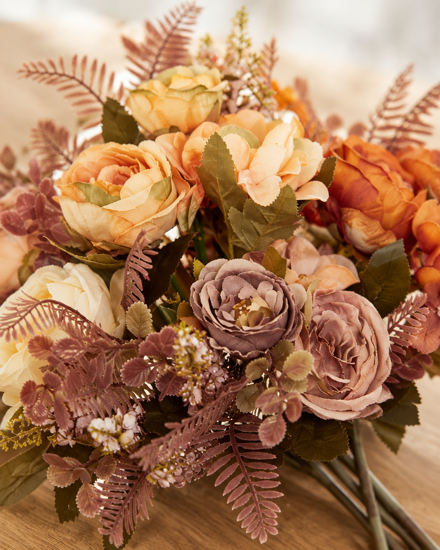 Close-up detail of the rust & cream artificial peony autumn bouquet on an oak table