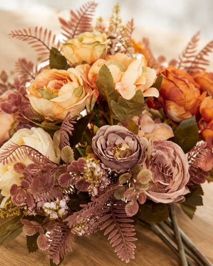 Close-up detail of the rust & cream artificial peony autumn bouquet on an oak table