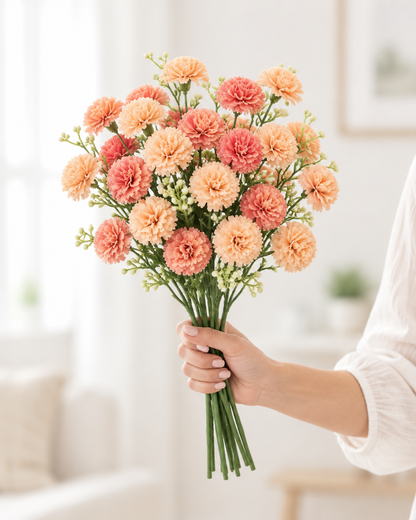 Peach and Coral Artificial Carnation Bouquet held in a hand