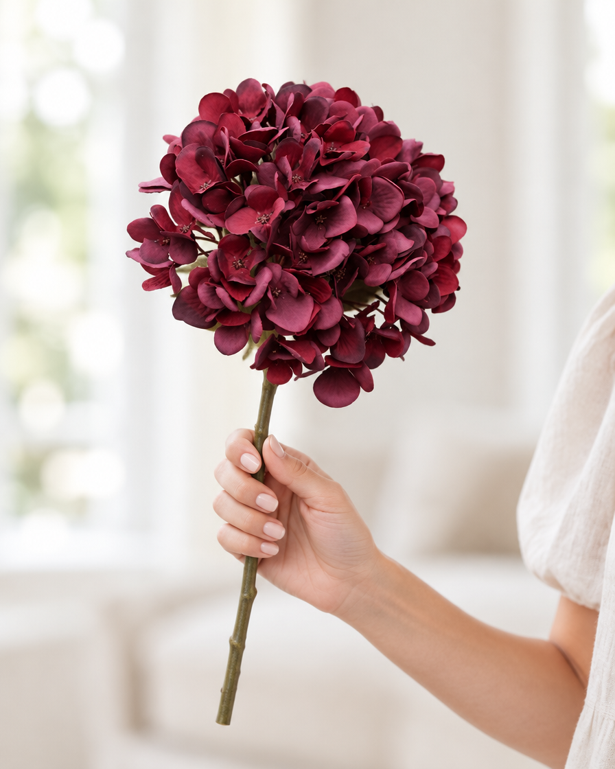 Burgundy Artificial Hydrangea Stem held in a hand