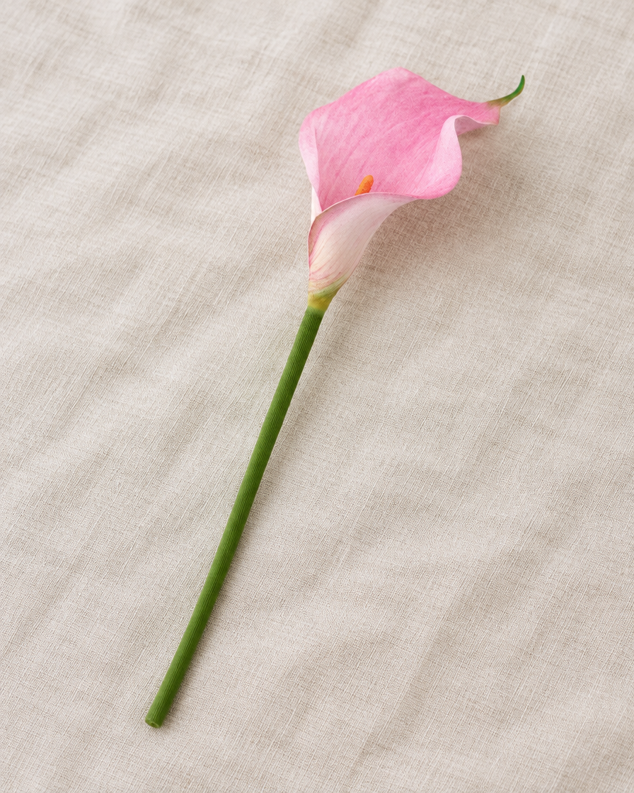 Pink Artificial Calla Lily Stem, shown alone on a linen background
