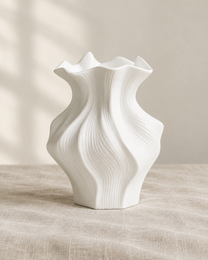 White Wavy Sculptural Ceramic Vase, shown alone on a linen background