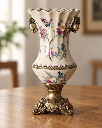 Close-up of the finish of the cream floral porcelain vase with bronze-tone base