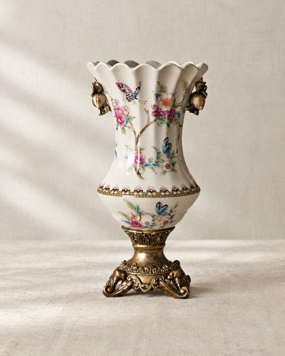 Cream Floral Porcelain Vase with Bronze-Tone Base, shown alone on a linen background