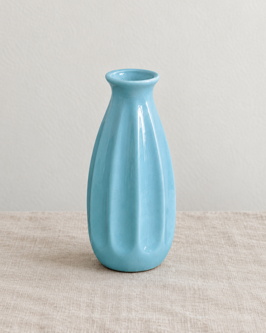 Light Blue Ribbed Ceramic Mini Vase, shown alone on a linen background