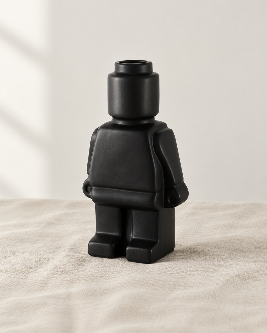 Matte Black Blocky Figure Ceramic Vase, shown alone on a linen background