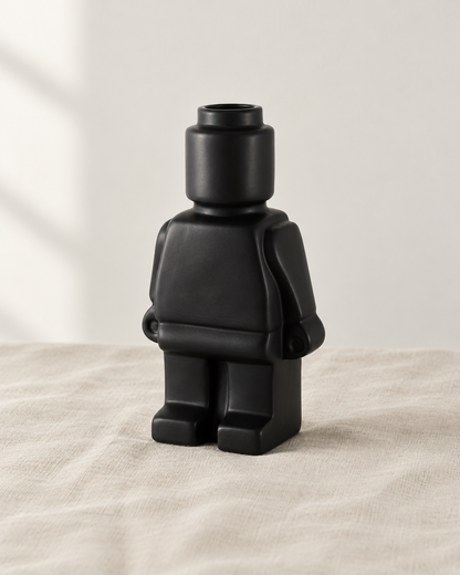 Matte Black Blocky Figure Ceramic Vase, shown alone on a linen background
