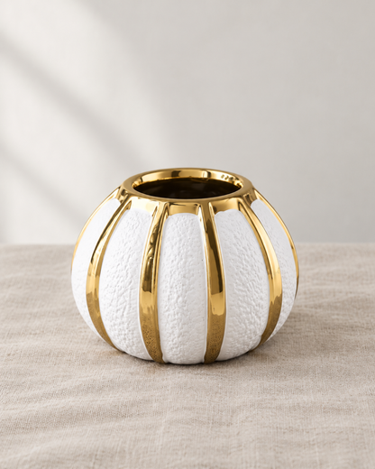 White Pumpkin Vase with Gold Stripes, shown alone on a linen background